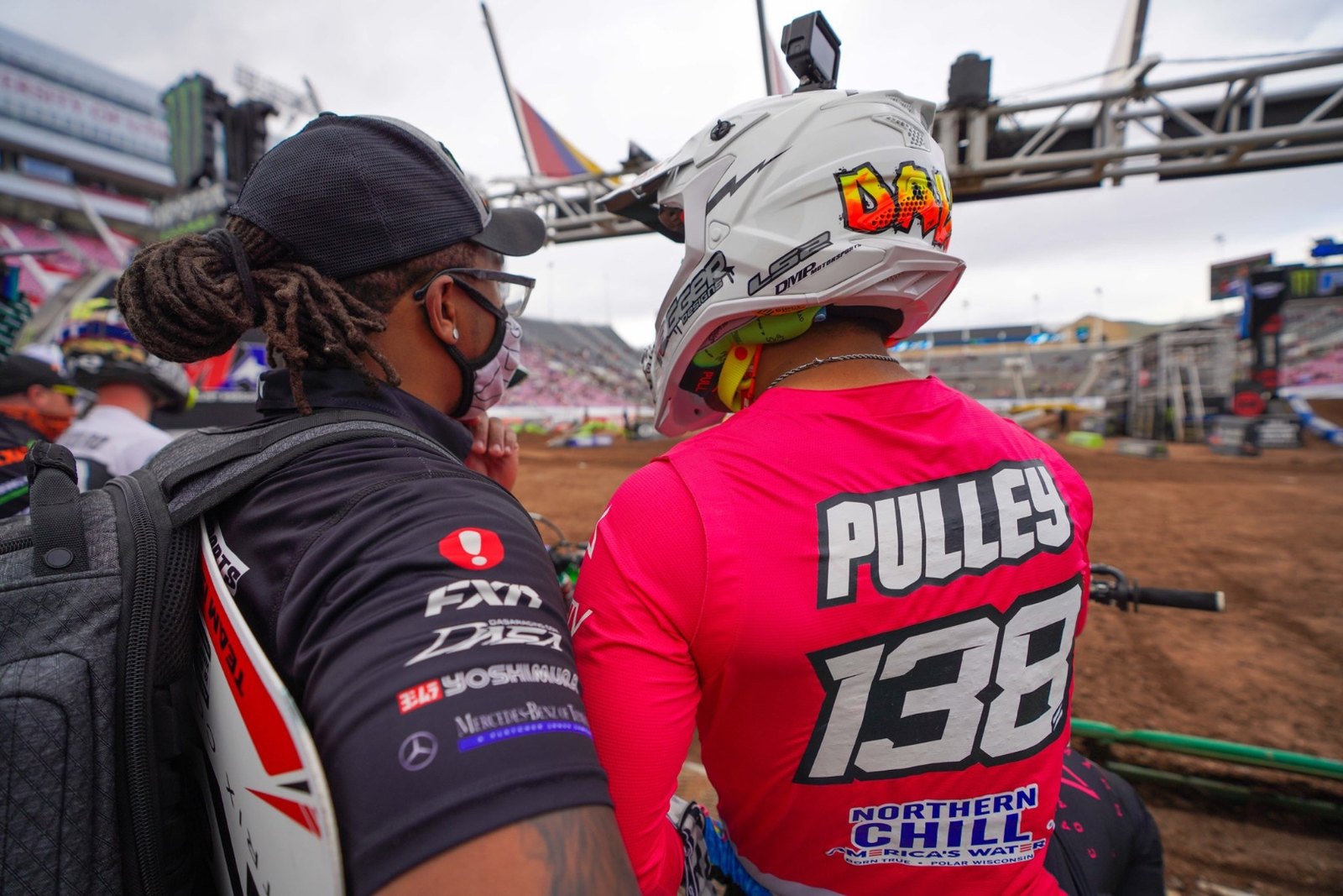 David Pulley number 138 in a pink race jersey on the Supercross start straight, Northern Chill America's Water branding across the lower back.