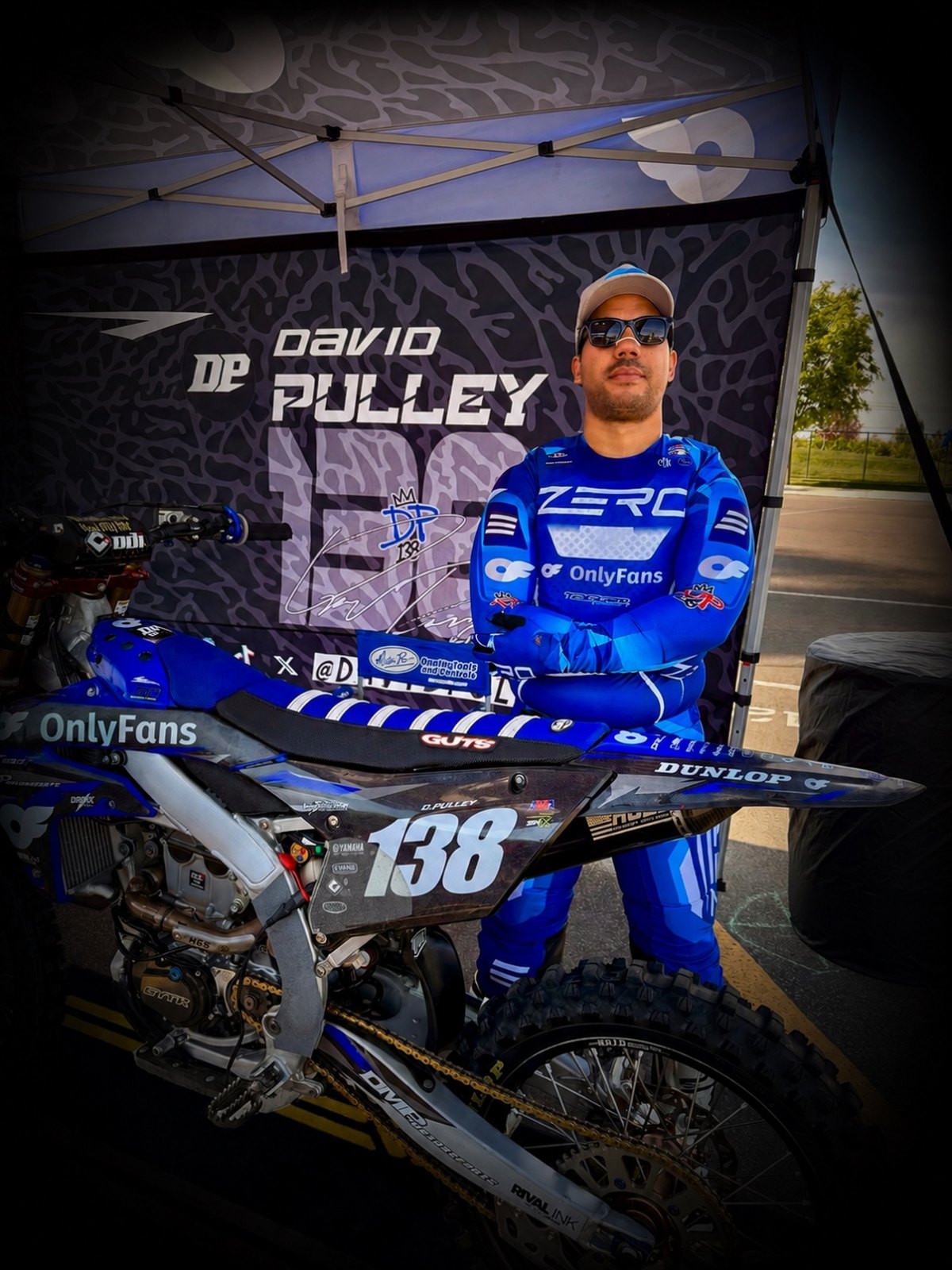 David Pulley Jr., professional Supercross athlete and founder of DPMX Media Lab, in his branded pit with his #138 Yamaha race bike